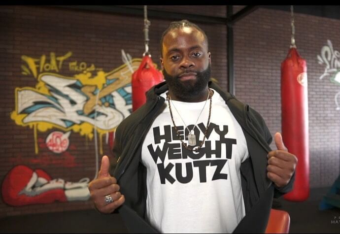 Barber wearing a white Heavyweight Kutz t-shirt in the boxing gym